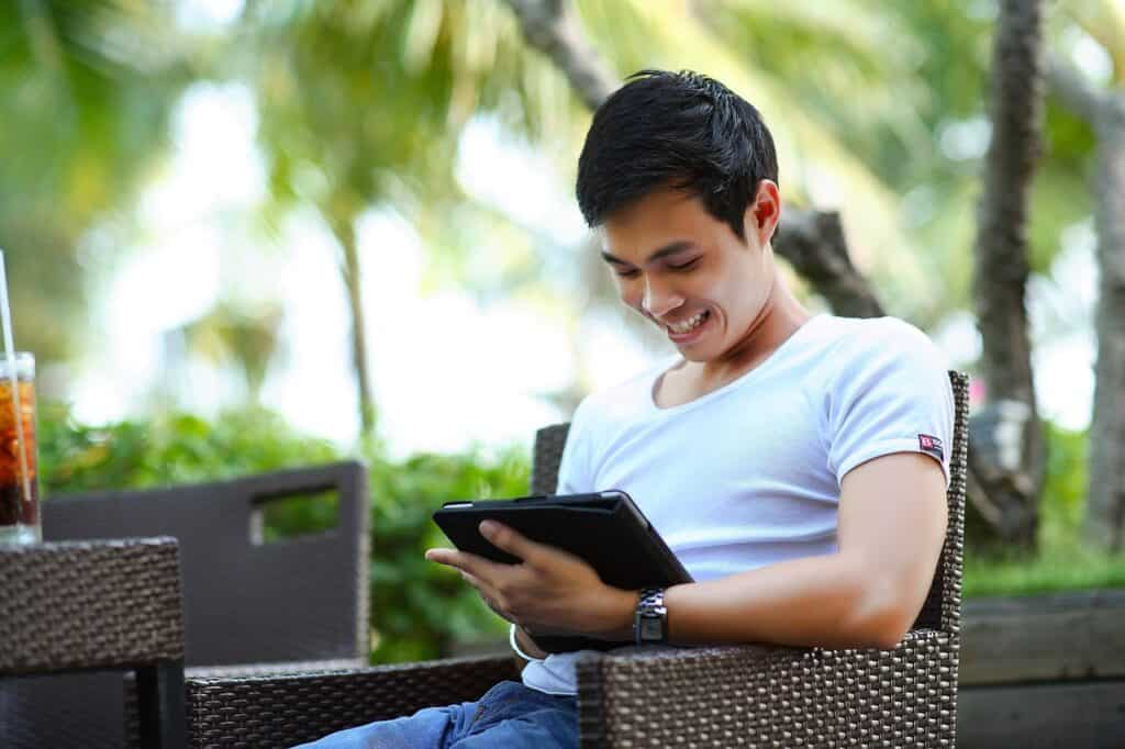 man on tablet viewing webinar